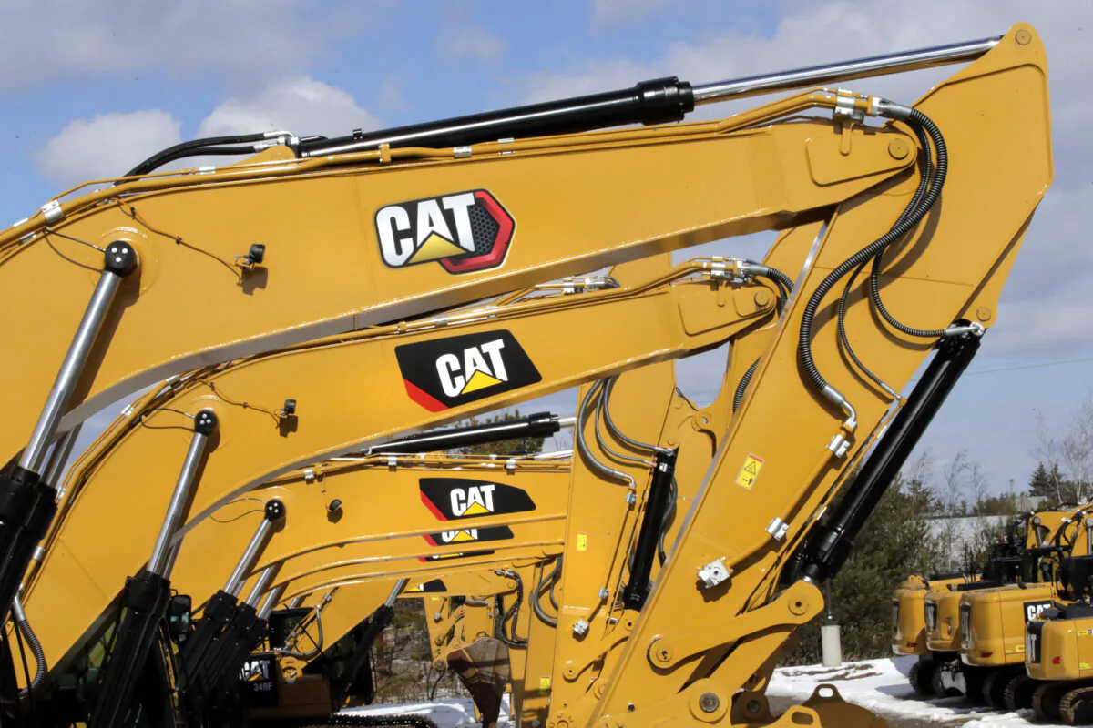 Excavator booms, adorned with the Caterpillar Inc. "CAT" logo are displayed at the Milton CAT dealership in Londonderry, N.H., on Feb. 20, 2020. (Charles Krupa/AP Photo)