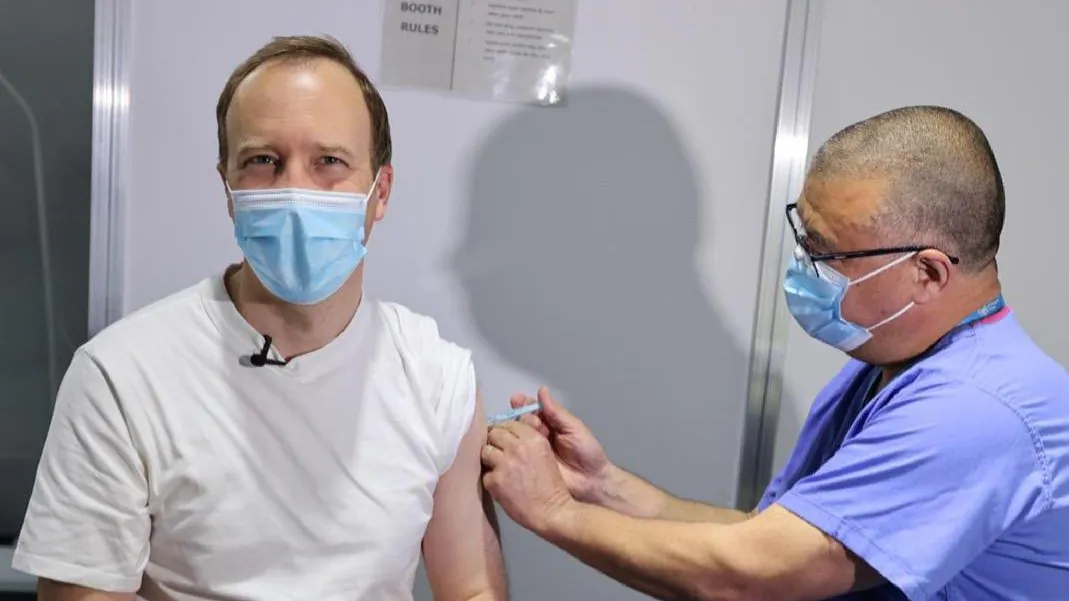 Jonathan Van-Tam, the deputy chief medical officer for England, administers a dose of the Oxford/AstraZeneca COVID-19 vaccine to UK Health Secretary Matt Hancock at a vaccination centre in London, on April 29, 2021. (UK Government)