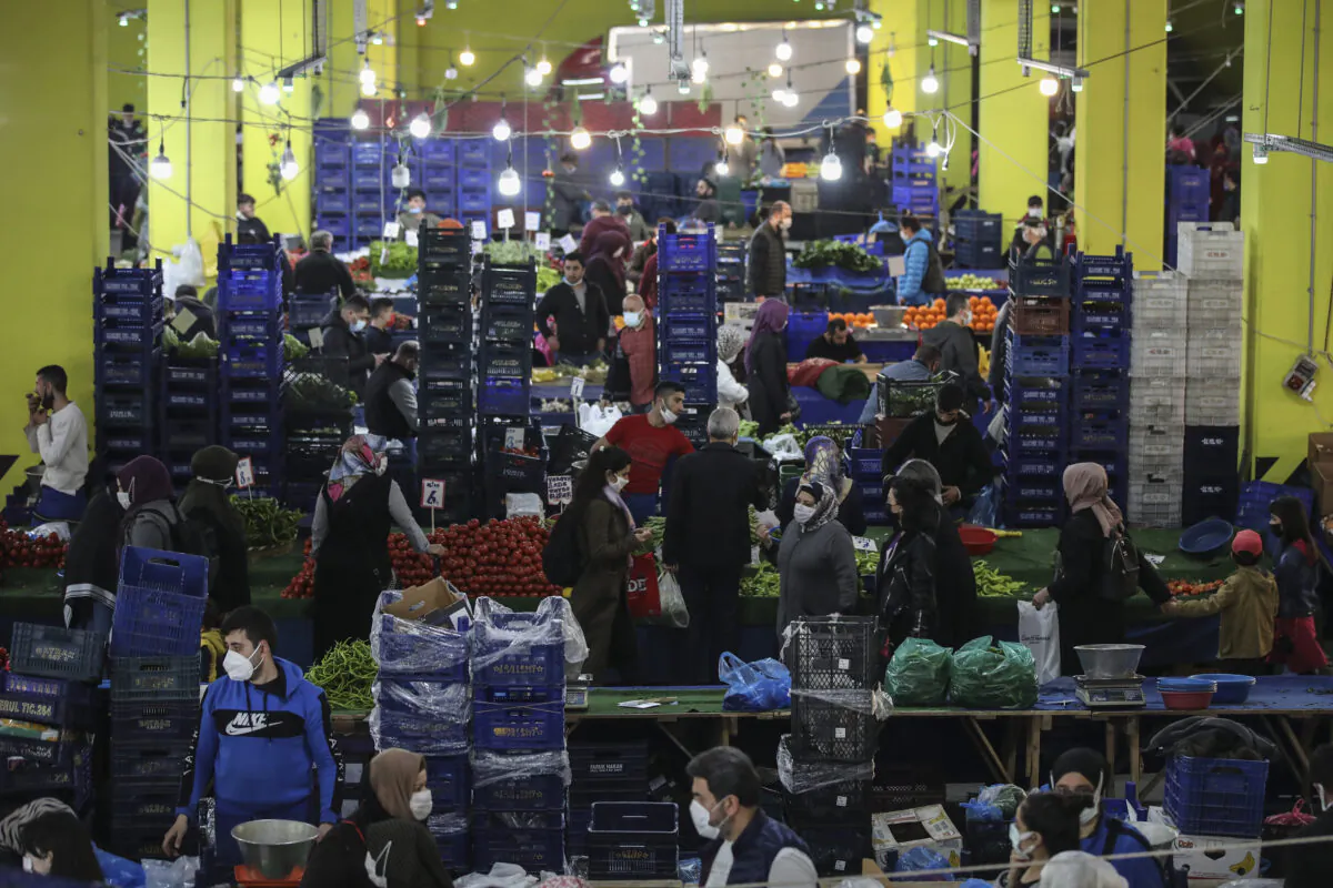 People shop at the local market in Istanbul a few hours before the start of the latest lockdown to help protect from the spread of the coronavirus, on April 29, 2021. (AP Photo/Emrah Gurel)