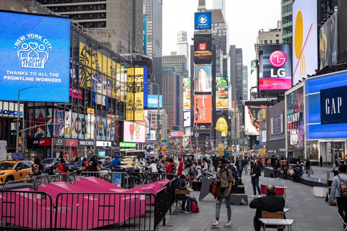 People wearing protective masks are seen in Times Square during the outbreak of the CCP virus in the Manhattan borough of New York City, N.Y., on March 25, 2021. (Jeenah Moon/Reuters)