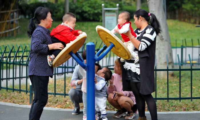Women play with children at a park in Jinhua, Zhejiang province, China, on Nov. 5, 2018. (Stringer/Reuters)