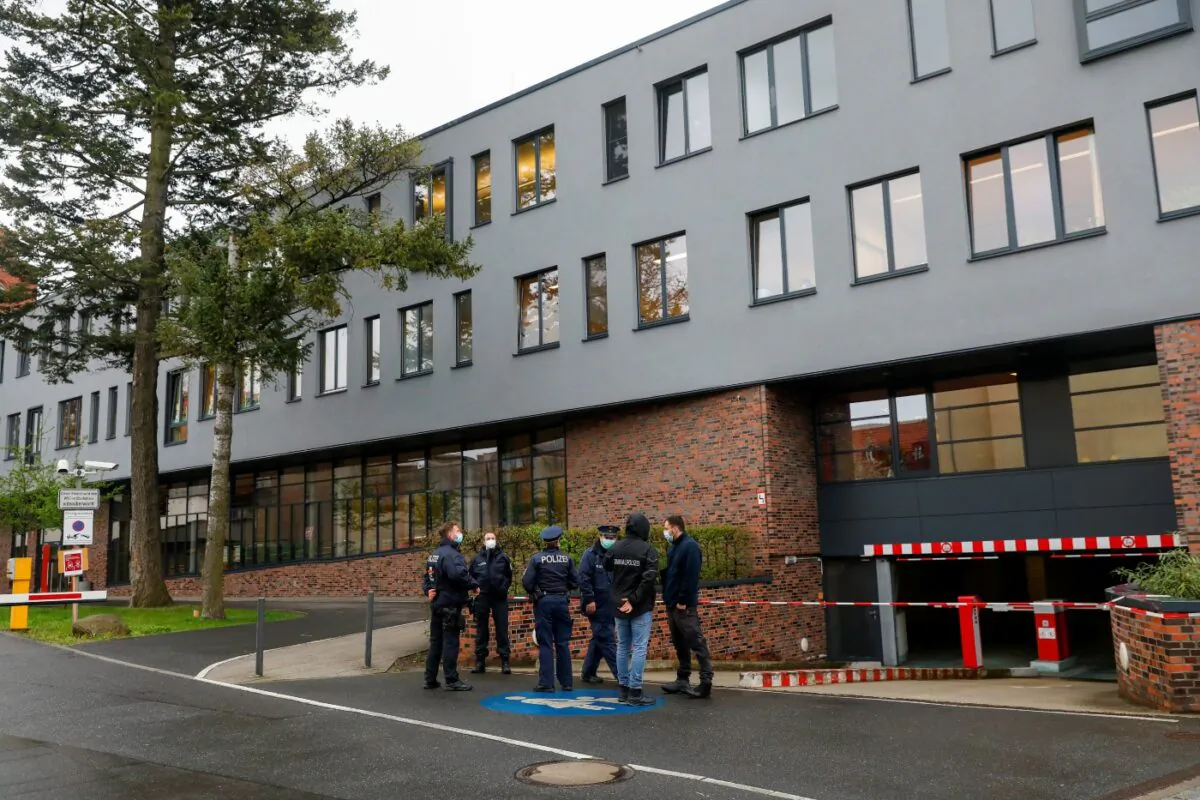 Police officers stand near the Oberlin Clinic, where four people were found dead and another seriously injured, following the arrest of a 51-year-old-woman in Potsdam, Germany, on April 29, 2021. (Michele Tantussi/Reuters)