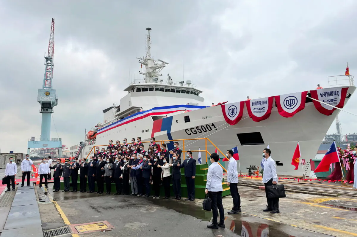 Taiwan President Tsai Ing-Wen and others pose for photos in front of the newly launched coast guard flagship Chiayi in Kaohsiung, Taiwan April 29, 2021. (Yimou Lee/Reuters)