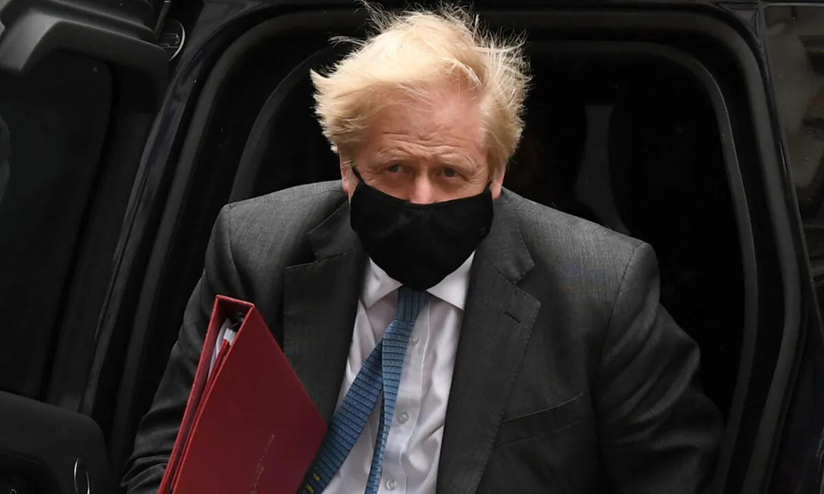 Britain's Prime Minister Boris Johnson wearing a face covering due to CCP virus pandemic, arrives back at 10 Downing Street in central London on April 28, 2021. (Daniel Leal-Olivas/AFP via Getty Images)