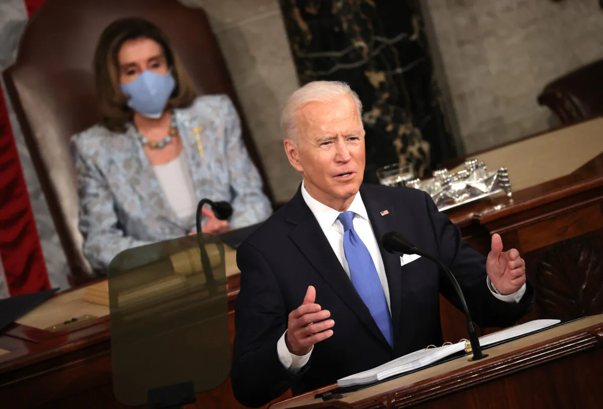 US President Joe Biden addresses a joint session of Congress as Speaker of the House US Rep. Nancy Pelosi (D-CA) (L) looks on in the House chamber of the US Capitol in Washington, DC, on April 28, 2021. (Chip Somodevilla/Getty Images)