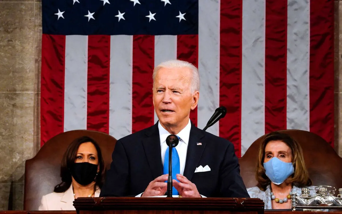 President Joe Biden, flanked by Vice President Kamala Harris, left, and House Speaker Nancy Pelosi, addresses a joint session of Congress at the Capitol in Washington on April 28, 2021. (Melina Mara/Pool/AFP via Getty Images)