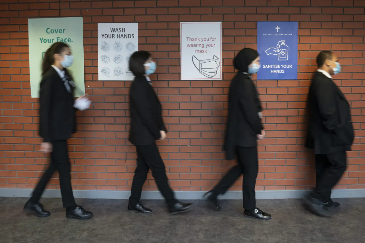 Students line up for a socially distanced assembly at a school in Manchester, England, on March 8, 2021. (Jon Super/PA via AP)