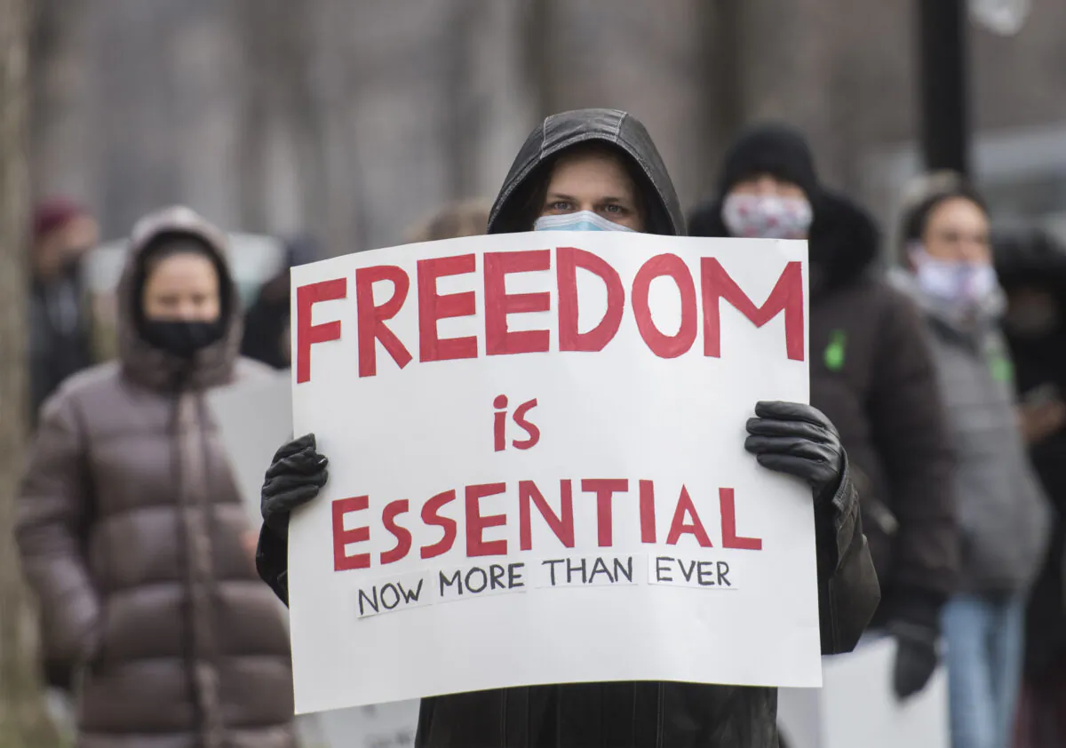 A file photo shows people protesting against COVID-19 measures in Montreal on Nov. 28, 2020. A similar large-scale protest was held in the city on May 1, 2021. (The Canadian Press/Graham Hughes)