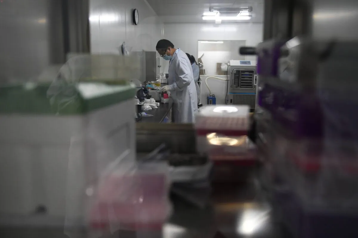 Technicians in a research and development lab at Chinese biotech company Coyote, which developed the Flash 20, a fast test for COVID-19, in Beijing, on Sept. 27, 2020. (Greg Baker/AFP via Getty Images)