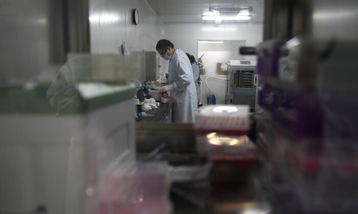Technicians in a research and development lab at Chinese biotech company Coyote, which developed the Flash 20, a fast test for COVID-19, in Beijing, on Sept. 27, 2020. (Greg Baker/AFP via Getty Images)