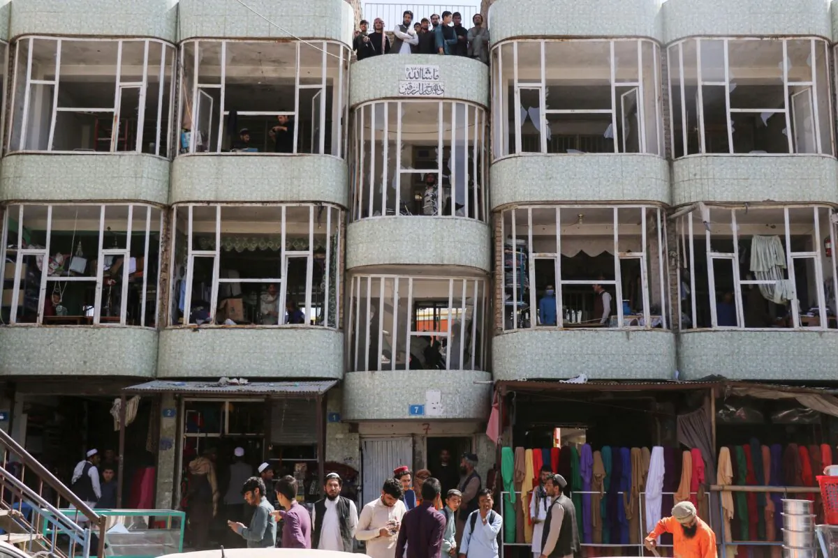 People look out from a damaged buidling a day after a car bomb attack in the Pul-e-Alam area in Logar province on May 1, 2021. (Photo by AFP via Getty Images)