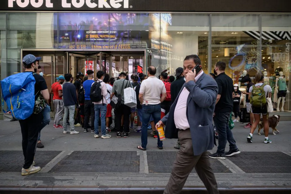 Shoppers queue outside a show store in New York on May 19, 2021. (Ed Jones/AFP via Getty Images)