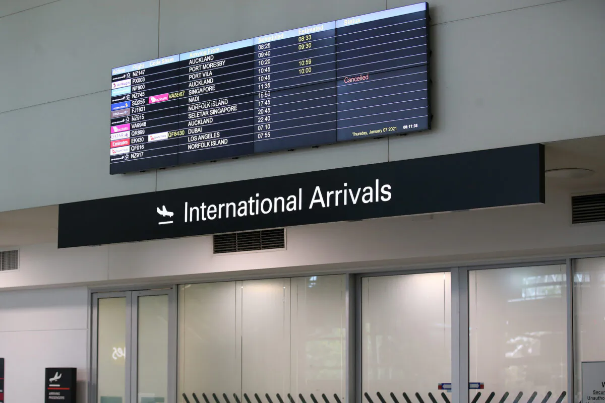A digital screen displays flight arrival times at Brisbane Airport in Queensland, Australia, on Jan. 7, 2021. (Jono Searle/Getty Images)