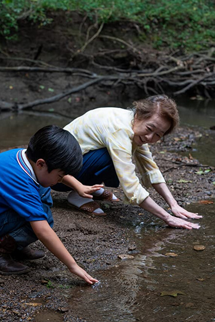 boy and elderly woman at a creek in Minari