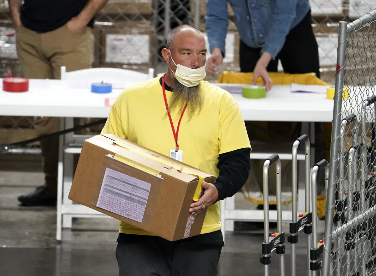 A box of ballots cast in the 2020 election are delivered to be examined and recounted by contractors working for Florida-based company, Cyber Ninjas, who was hired by the Arizona Senate, at Veterans Memorial Coliseum in Phoenix, Ariz., on April 29, 2021. (Rob Schumacher/The Arizona Republic via AP/Pool)