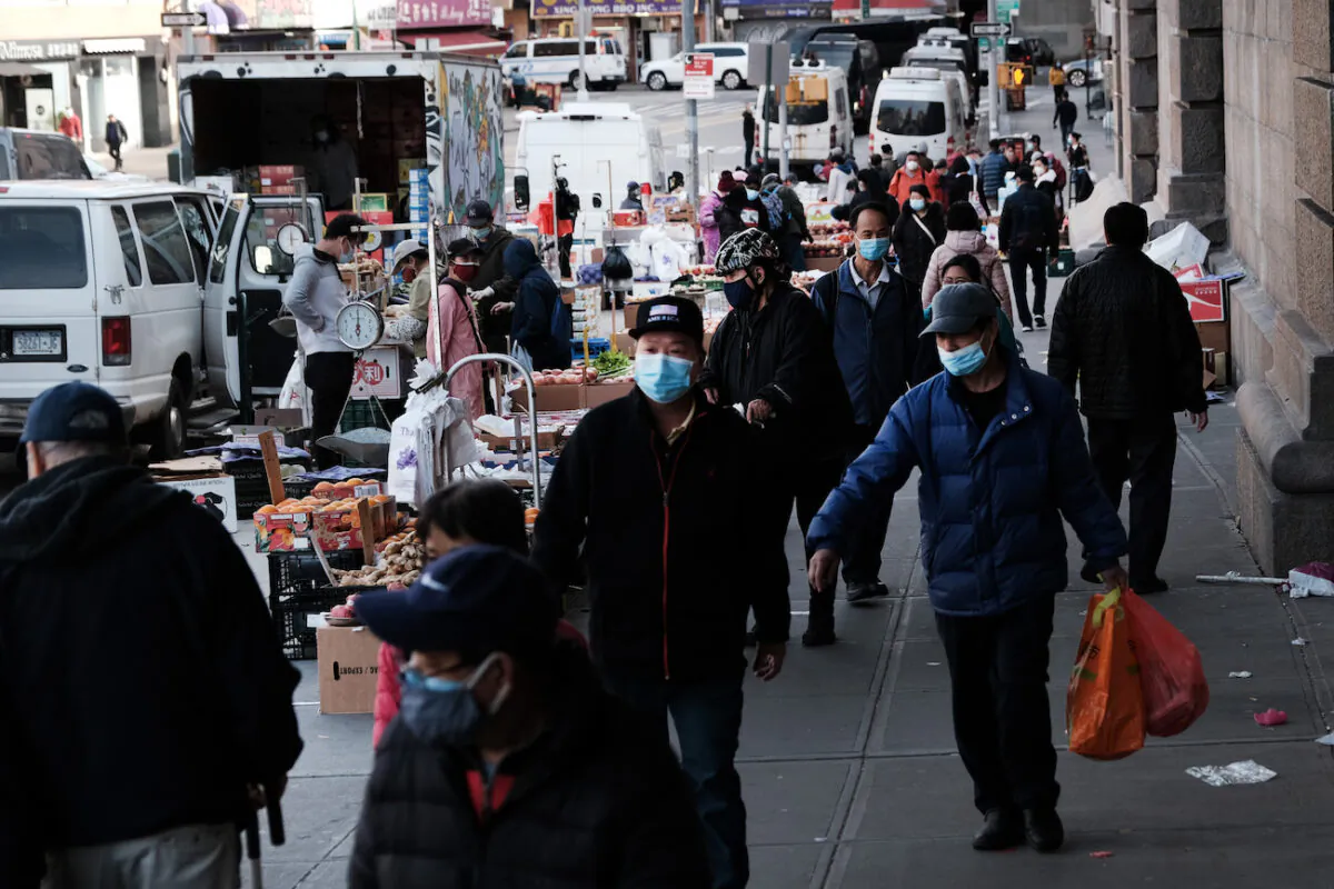 People walk through the streets of Chinatown in New York City, on March 23, 2021. (Spencer Platt/Getty Images)