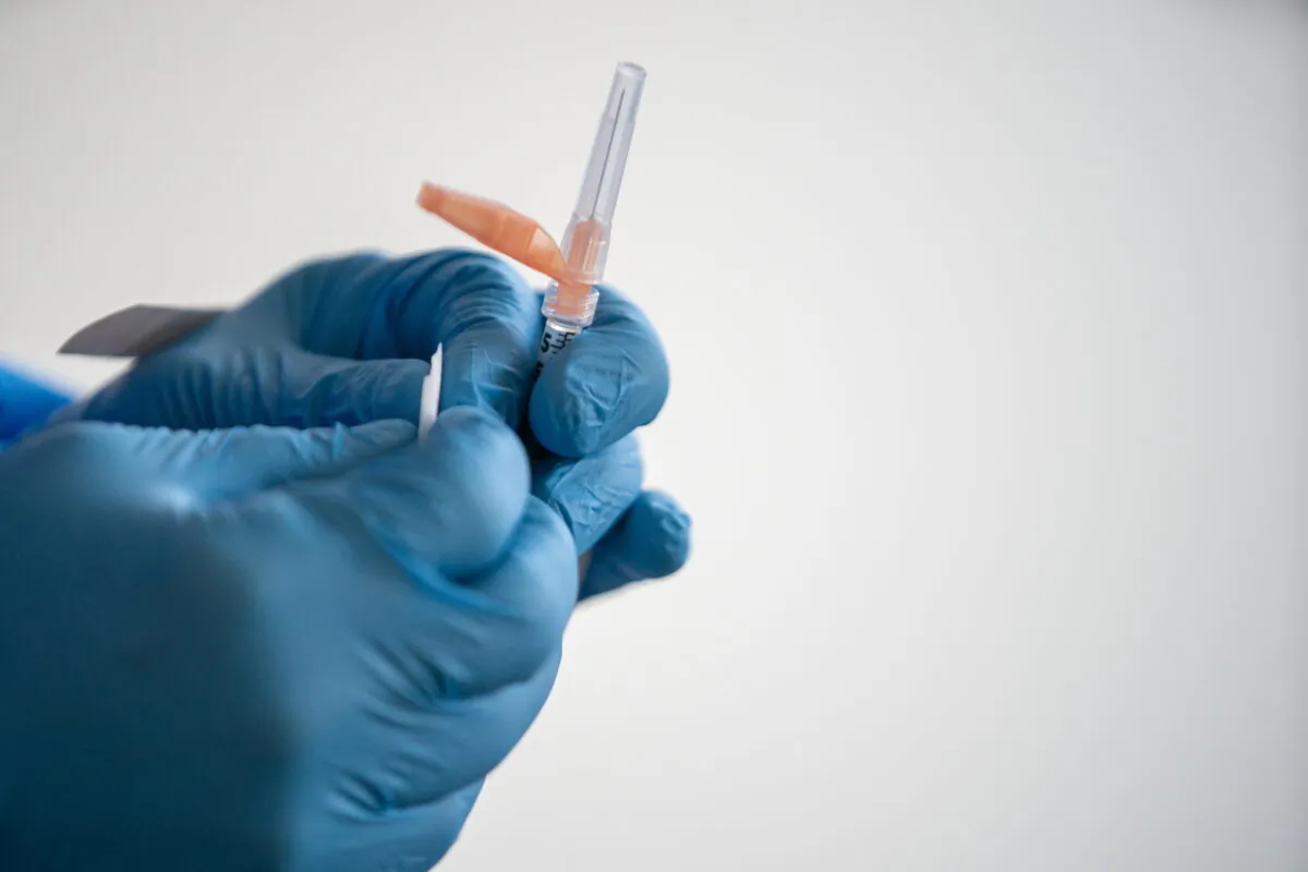 A nurse holds a syringe with a COVID-19 vaccine in New York City on Feb. 25, 2021. (Jeenah Moon/Reuters)