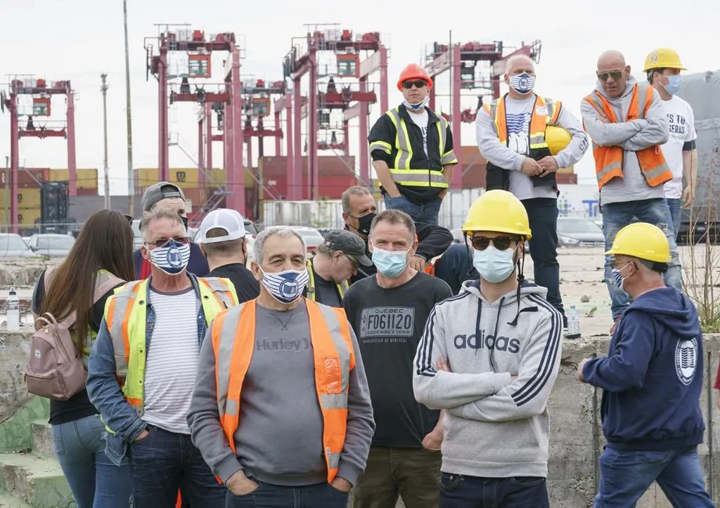 Striking Port of Montreal dockworkers listen to speeches during a rally in Montreal on April 29, 2021. (The Canadian Press/Paul Chiasson)