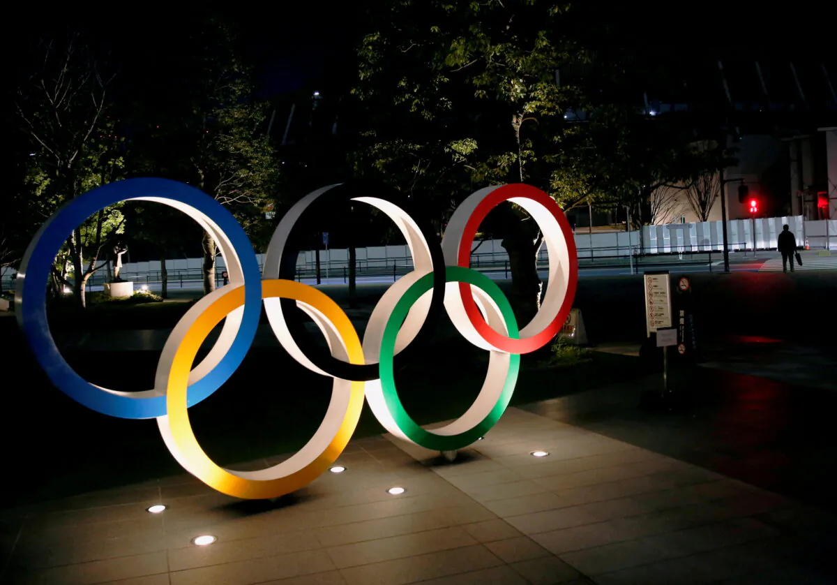 The Olympic rings are illuminated in front of the National Stadium in Tokyo, Japan, on Jan. 22, 2021. (Kim Kyung-Hoon/Reuters)