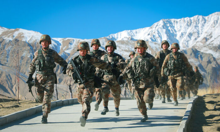 Chinese People's Liberation Army (PLA) soldiers taking part in military training at Pamir Mountains in Kashgar, northwestern China's Xinjiang region, on Jan. 4, 2021.  On another Western Theatre Command boundary,100 PLA soldiers intruded 3 miles into Indian territory at Barahoti in Uttrakhand state and destroyed some infrastructure. (STR/AFP via Getty Images)