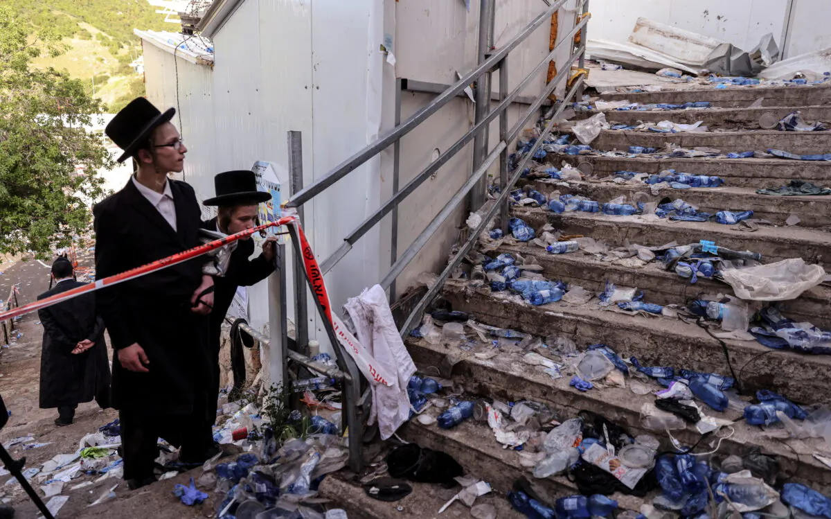 Ultra Orthodox Jews look at stairs with waste on it in Mount Meron, northern Israel, where fatalities were reported among the thousands of ultra-Orthodox Jews gathered at the tomb of a 2nd-century sage for annual commemorations that include all-night prayer and dance, on April 30, 2021. (Ronen Zvulun/Reuters)