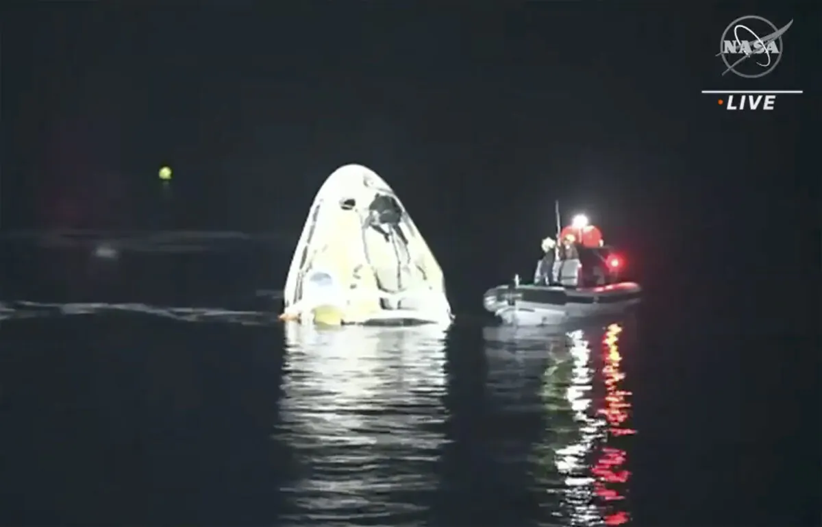In this image made from NASA TV video, the SpaceX Dragon capsule floats after landing in the Gulf of Mexico near the Florida Panhandle early Sunday, on May 2, 2021. (NASA TV via AP)