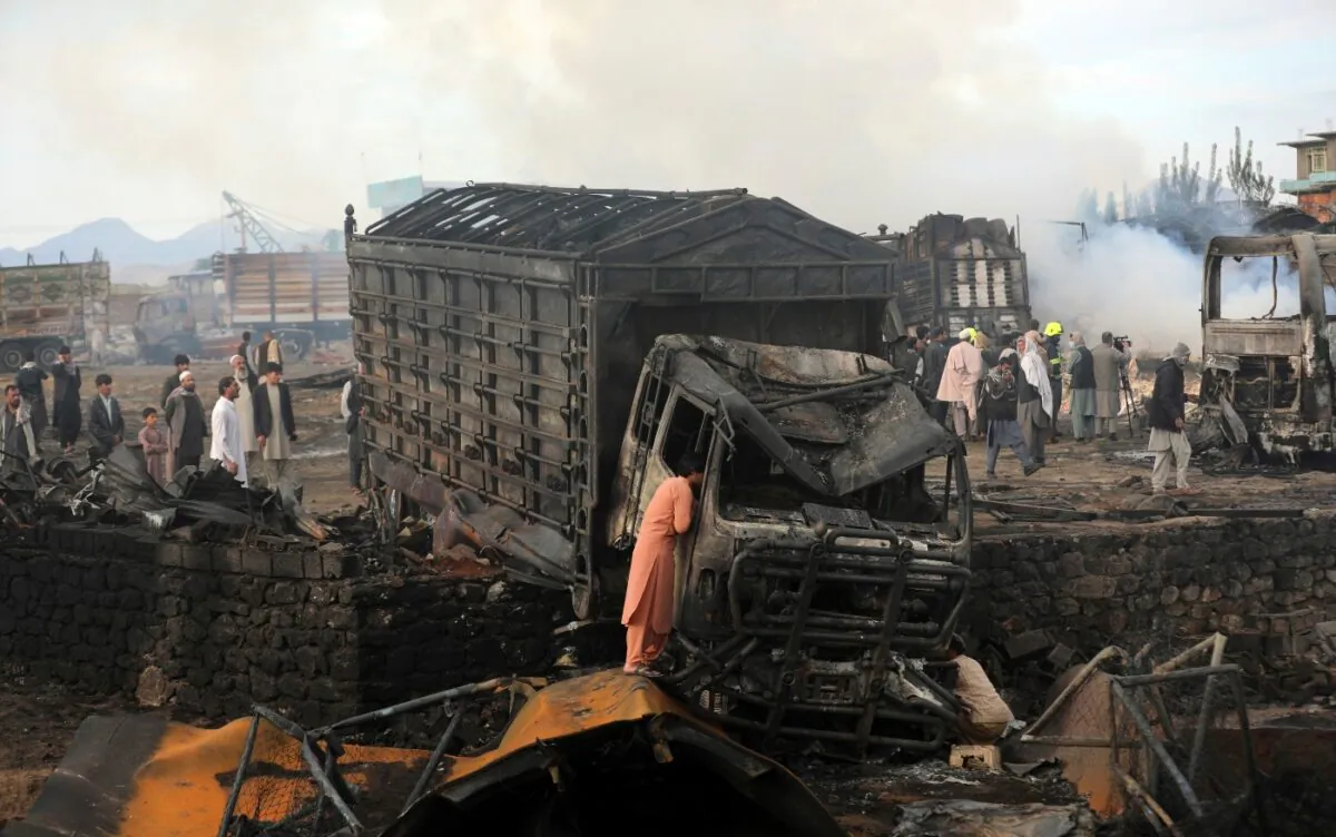 A driver views the damage of his truck caught in a fire in Kabul, Afghanistan, on May 2, 2021. (Rahmat Gul/AP Photo)
