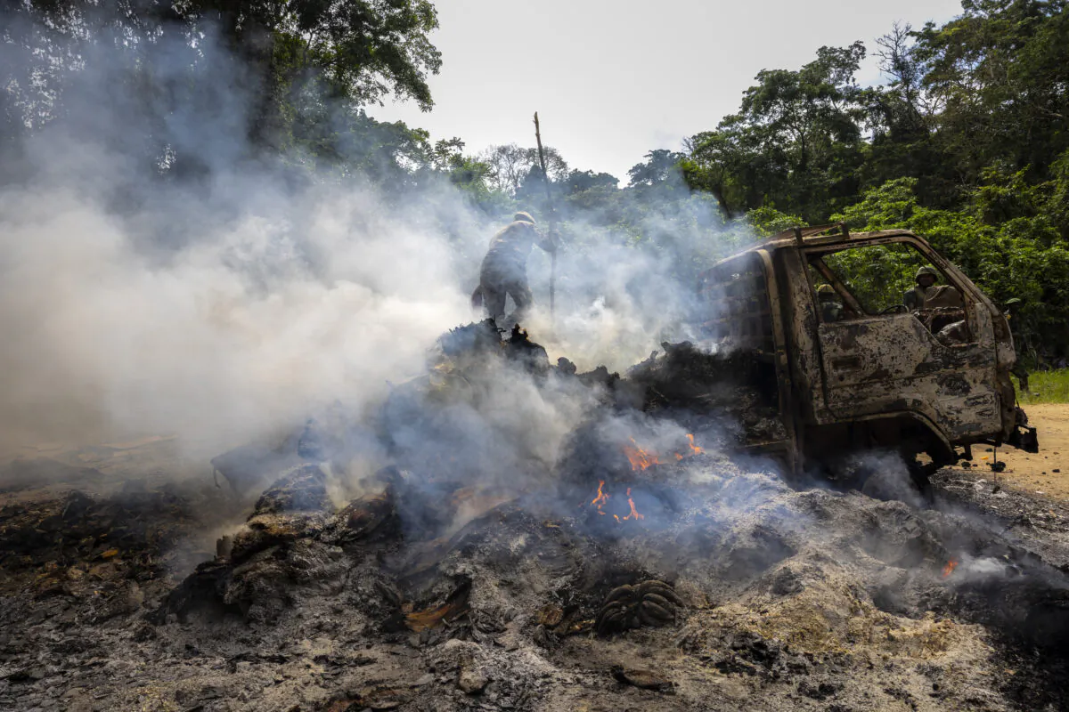 Congolese Army soldiers and UN forces inspect an ambush site where an hour previously ADF terrorists attacked two vehicles on the road between Beni and the Ugandan border town of Kasindi, in Kilya, Rwenzori Sector, Democratic Republic of Congo, on April 9, 2021. (Brent Stirton/Getty Images)