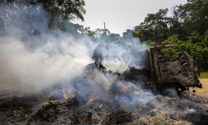 Congolese Army soldiers and UN forces inspect an ambush site where an hour previously ADF fundamentalist rebels attacked two vehicles on the road between Beni and the Ugandan border town of Kasindi, in Kilya, Rwenzori Sector, Democratic Republic of Congo, on April 9, 2021. (Brent Stirton/Getty Images)