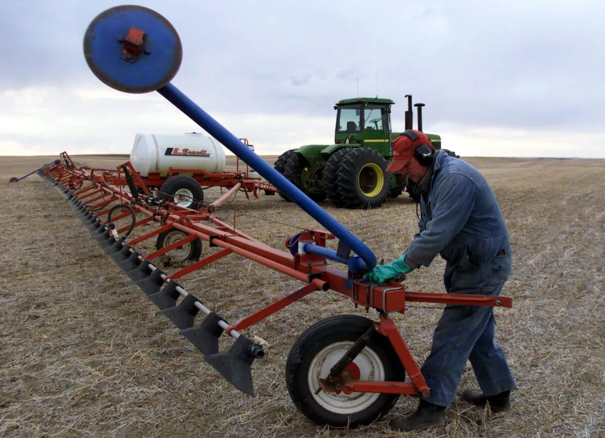 A farmer prepares machinery to spray herbicide on a field near Mossbank, Saskatchewan, in a file photo. (CP Photo/Adrian Wyld)