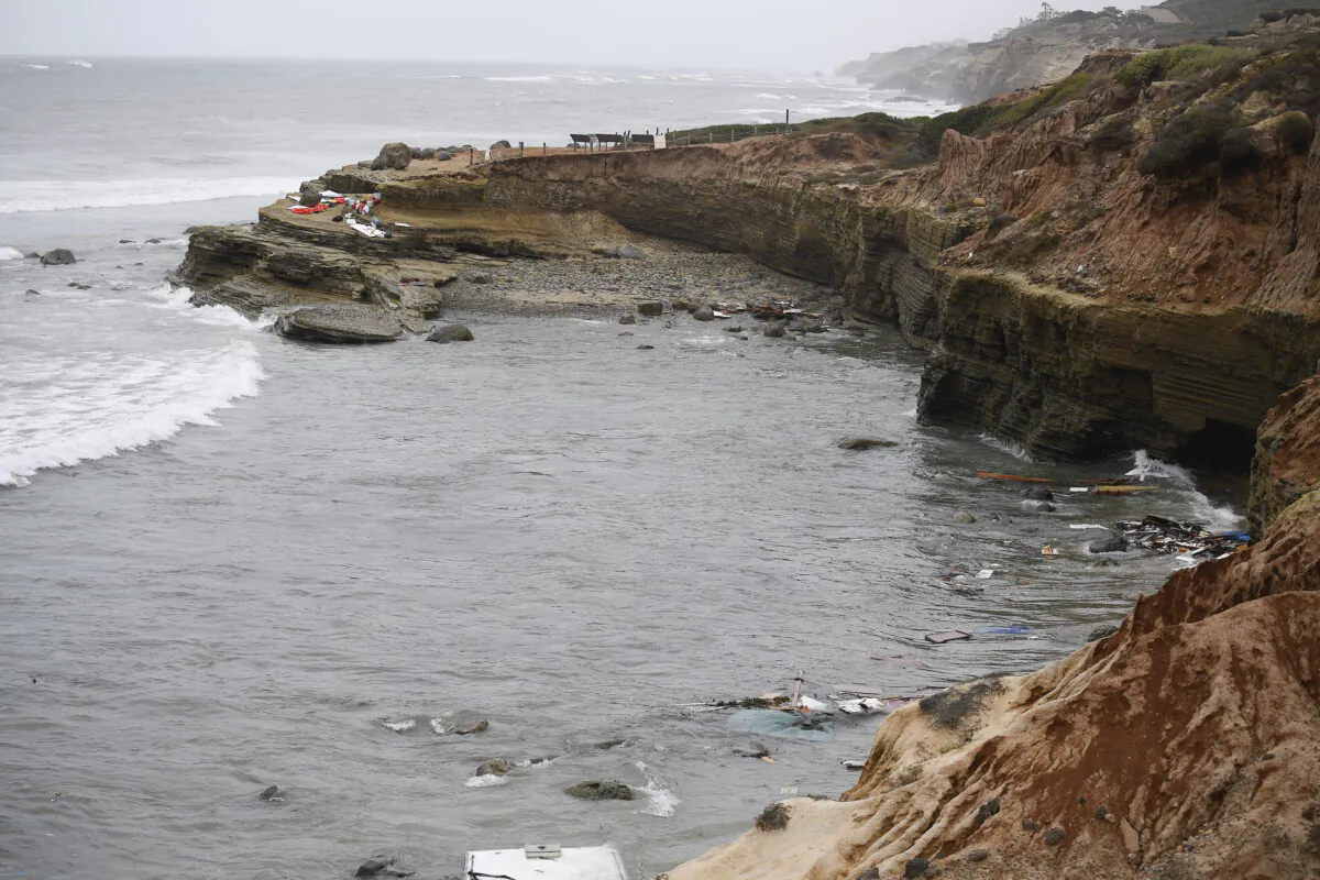 Wreckage and debris from a capsized boat washes ashore at Cabrillo National Monument near where a boat capsized just off the San Diego coast, Calif., on May 2, 2021. (Denis Poroy/AP Photo)