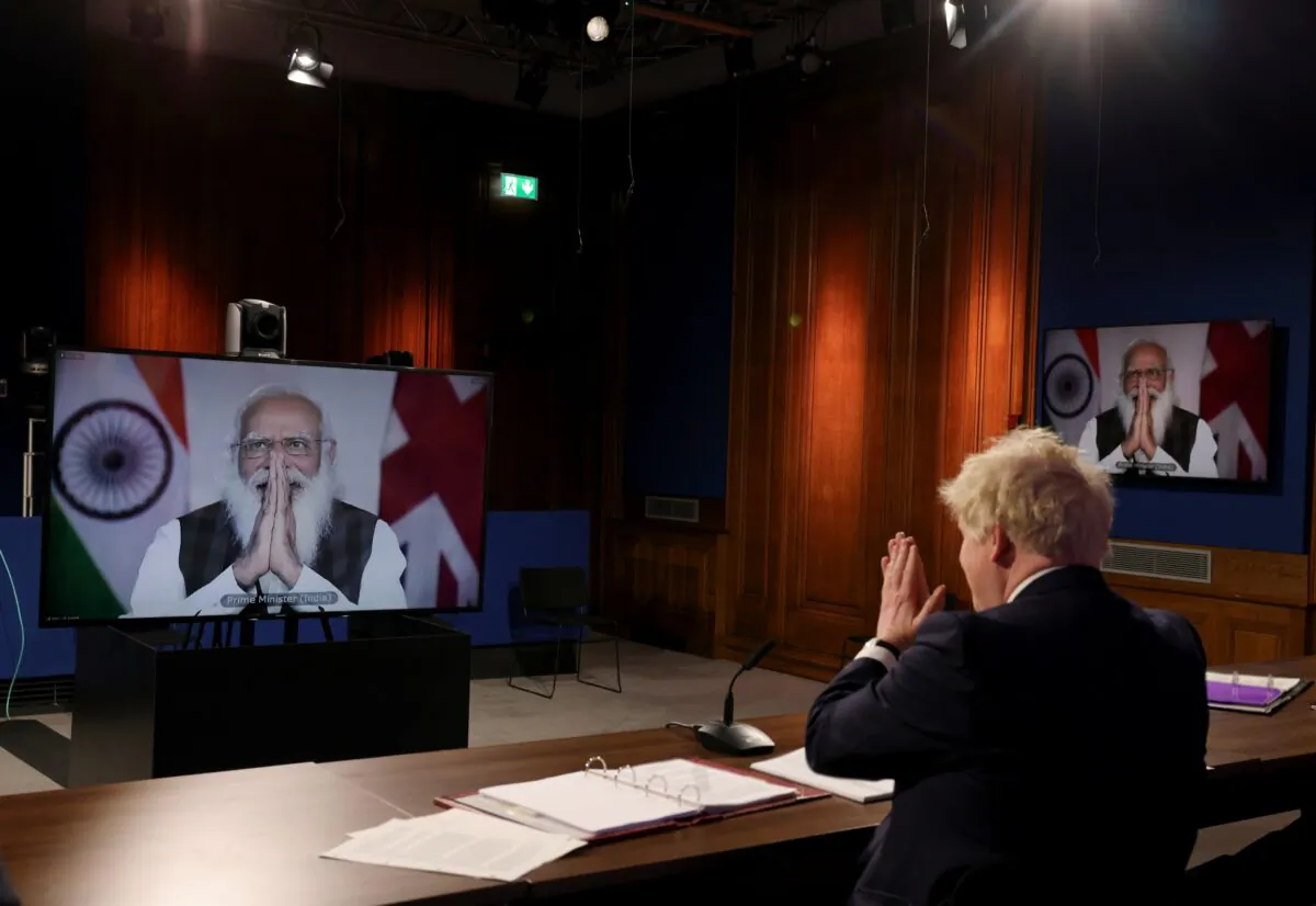 British Prime Minister Boris Johnson and his Indian counterpart Narendra Modi greet each other during a virtual meeting on May 4, 2021. (UK Prime Minister’s Office)