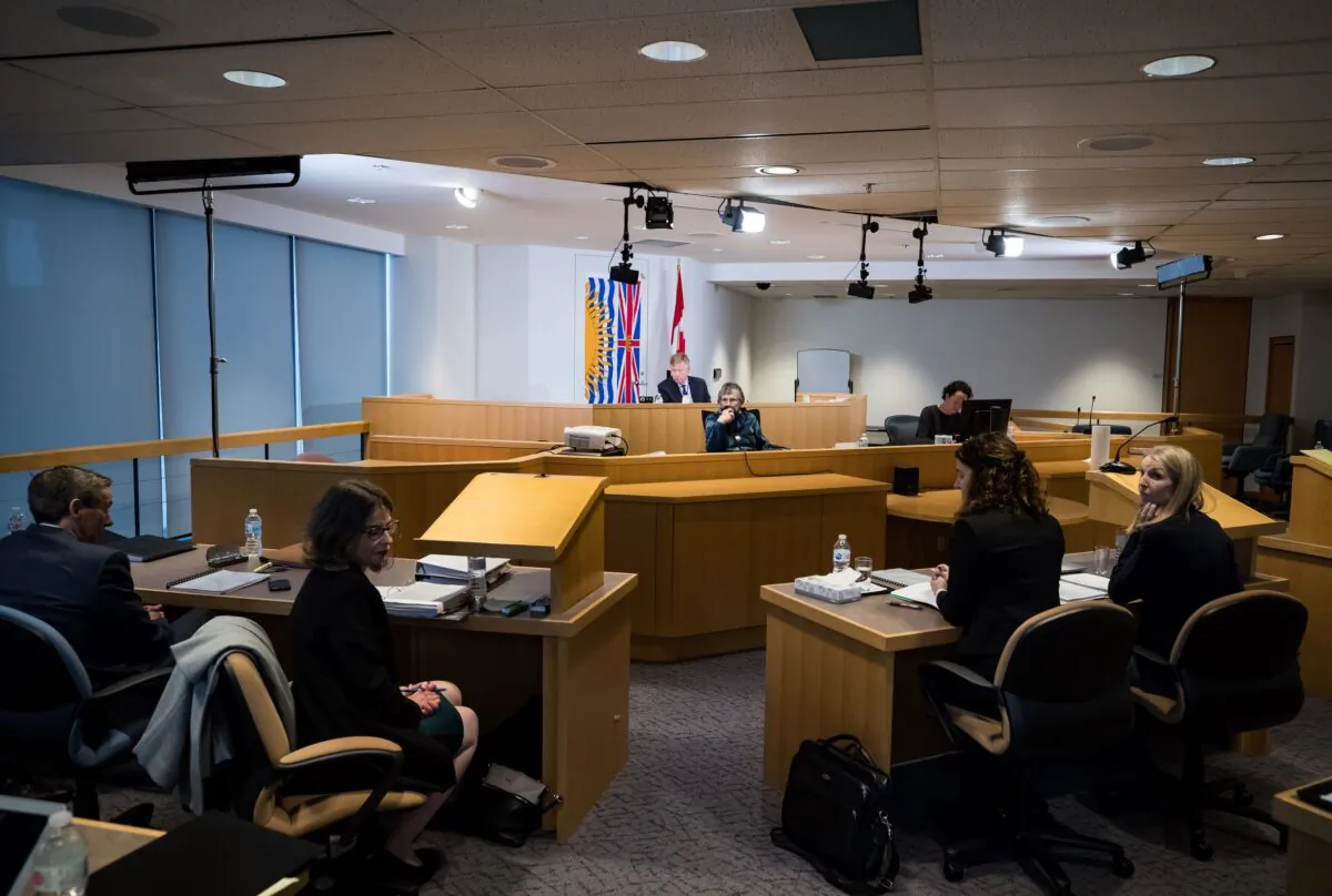 Commissioner Austin Cullen (back) listens to introductions before opening statements at the Cullen Commission of Inquiry into Money Laundering in British Columbia, in Vancouver on Feb. 24, 2020. (The Canadian Press/Darryl Dyck)