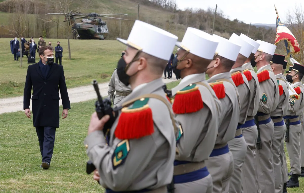 French President Emmanuel Macron reviews soldiers of the 4th Regiment during a military honors ceremony at  the 4th Regiment of the Foreign Legion's training center in La Ferme du Cuin, in Saint-Gauderic, France, on March 12, 2021. (Stephane Mahe/X02520/AFP via Getty Images)