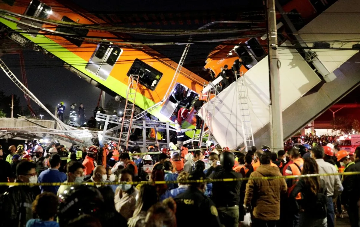Rescuers work at a site where an overpass for a metro partially collapsed with train cars on it at Olivos station in Mexico City, Mexico on May 3, 2021. (Luis Cortes/Reuters)