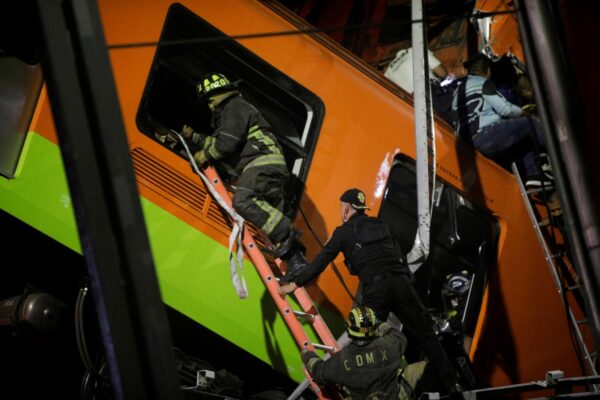 Rescuers work at a site where an overpass