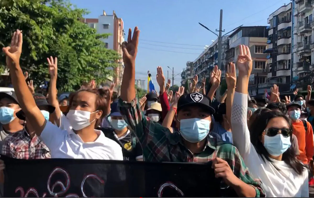 This screengrab from AFPTV video footage taken on May 2, 2021, shows protesters making the three-finger salute as they take part in a flash mob as part of demonstrations against the military coup on "Global Myanmar Spring Revolution Day" in Yangon, Burma, on on May 2, 2021. (-/AFPTV/AFP via Getty Images)