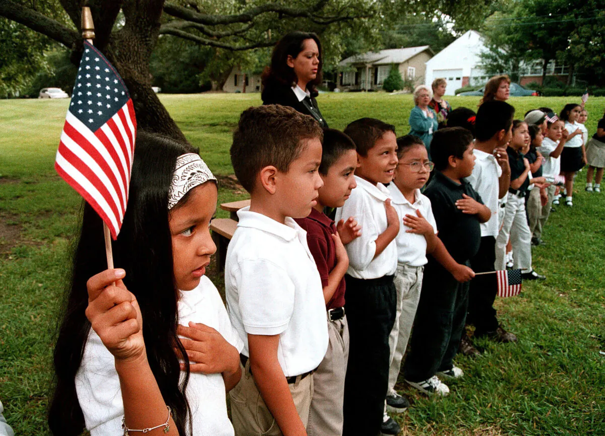 A class of Hispanic students recites the Pledge of Allegiance during a Sept. 11 memorial service at Birdwell Elementary School in Tyler, Texas. on Sep. 11, 2003. (Mario Villafuerte/Getty Images)