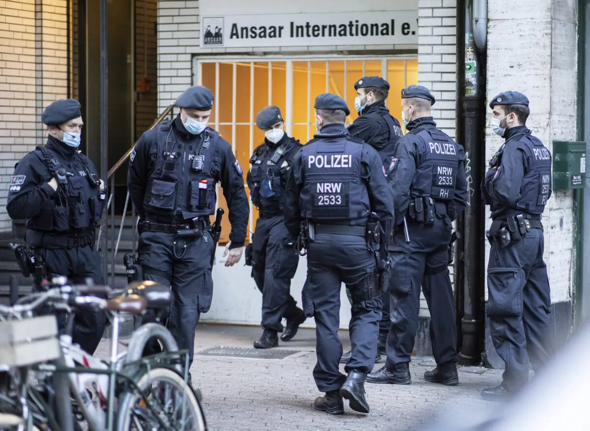Police officers stay in front of a building of the Ansaar International association in Duesseldorf, Germany, on May 5, 2021. (Marcel Kusch/dpa via AP)