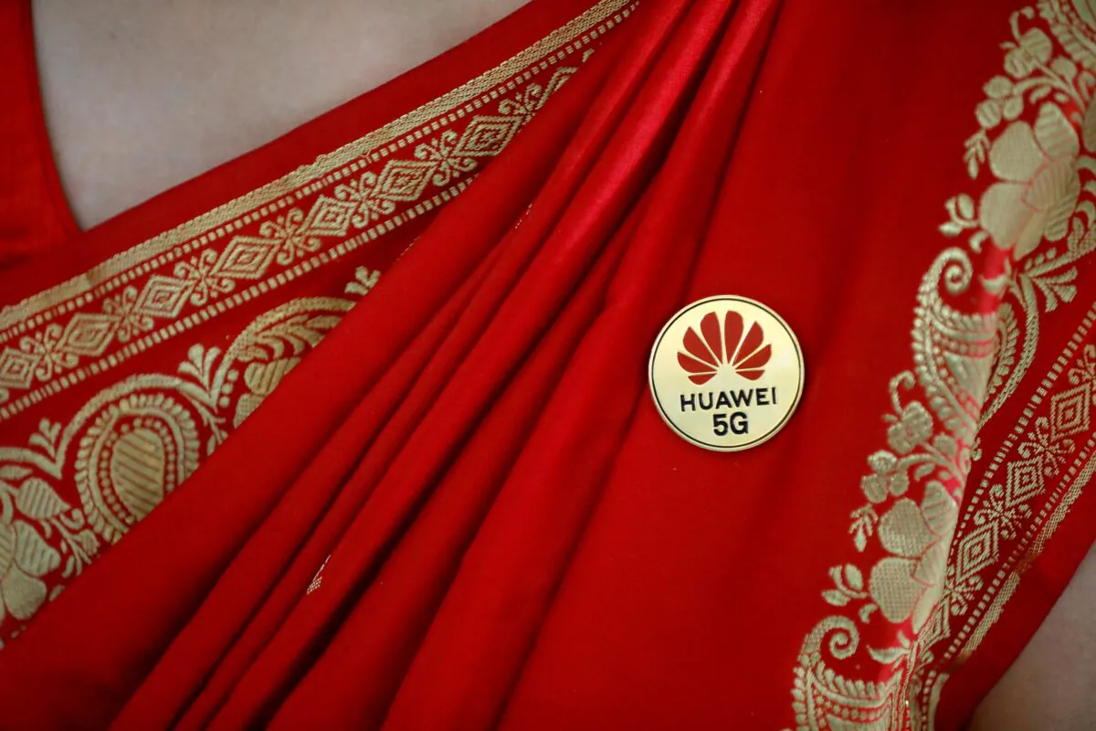 Huawei's logo is seen on a badge pinned on a saree of a lady at the India Mobile Congress in New Delhi, India, Oct. 14, 2019. (Anushree Fadnavis/Reuters)