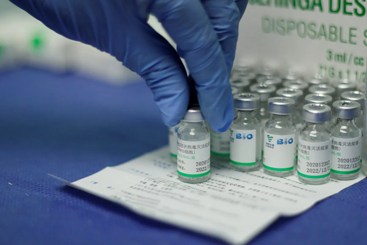 A nurse holds a vial of China's Sinopharm coronavirus disease (COVID-19) vaccine at a health center in Caracas, Venezuela, on March 7, 2021. (Leonardo Fernandez Viloria/Reuters)