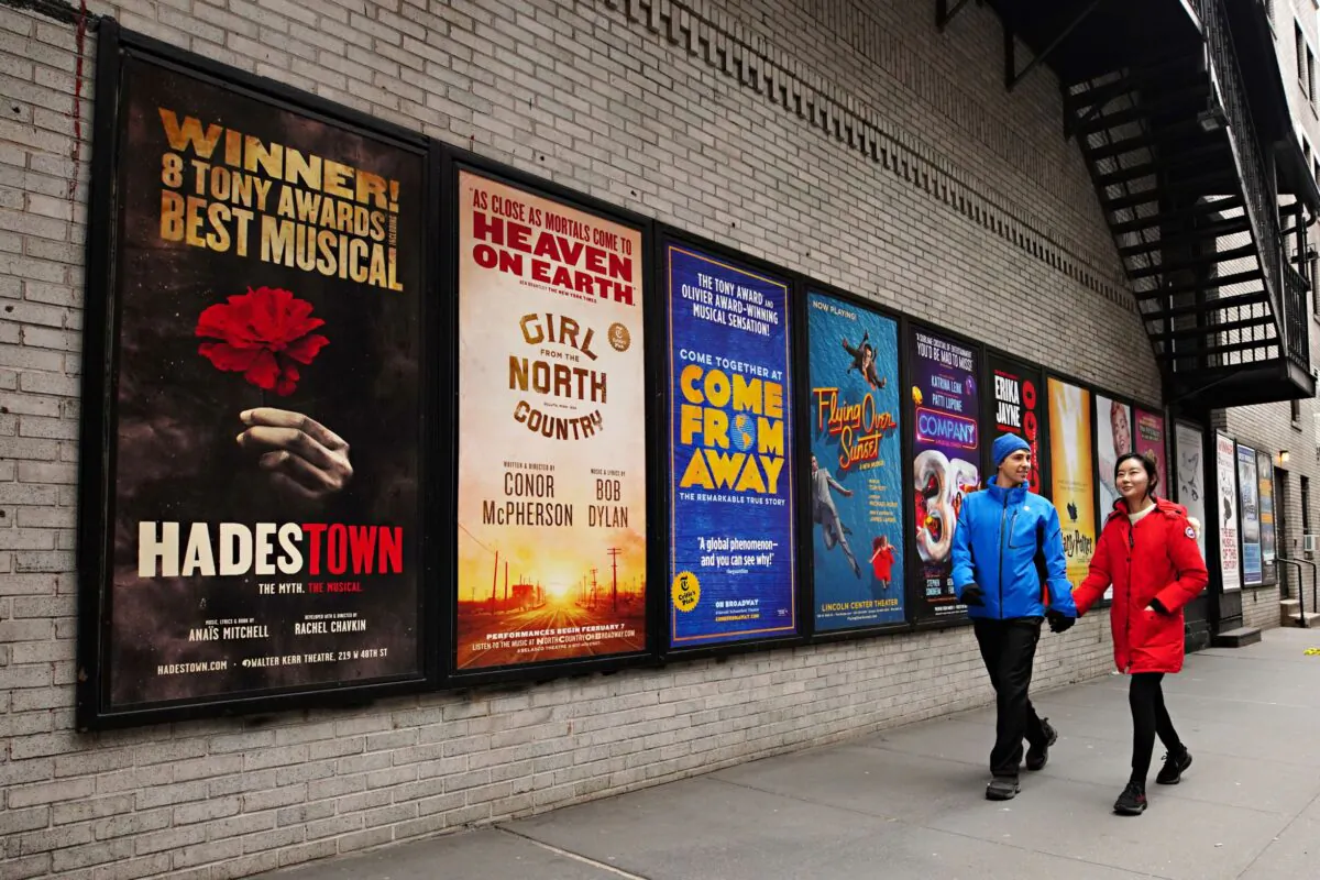 People walk by Broadway posters near Times Square as theaters across the city remain closed following restrictions imposed to slow the spread of coronavirus in New York City on Jan. 13, 2021. (Cindy Ord/Getty Images)