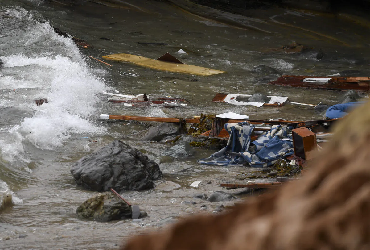 Wreckage and debris from a capsized boat washes ashore at Cabrillo National Monument near where a boat capsized just off the San Diego coast, in San Diego, Calif., on May 2, 2021. (Denis Poroy/AP Photo)