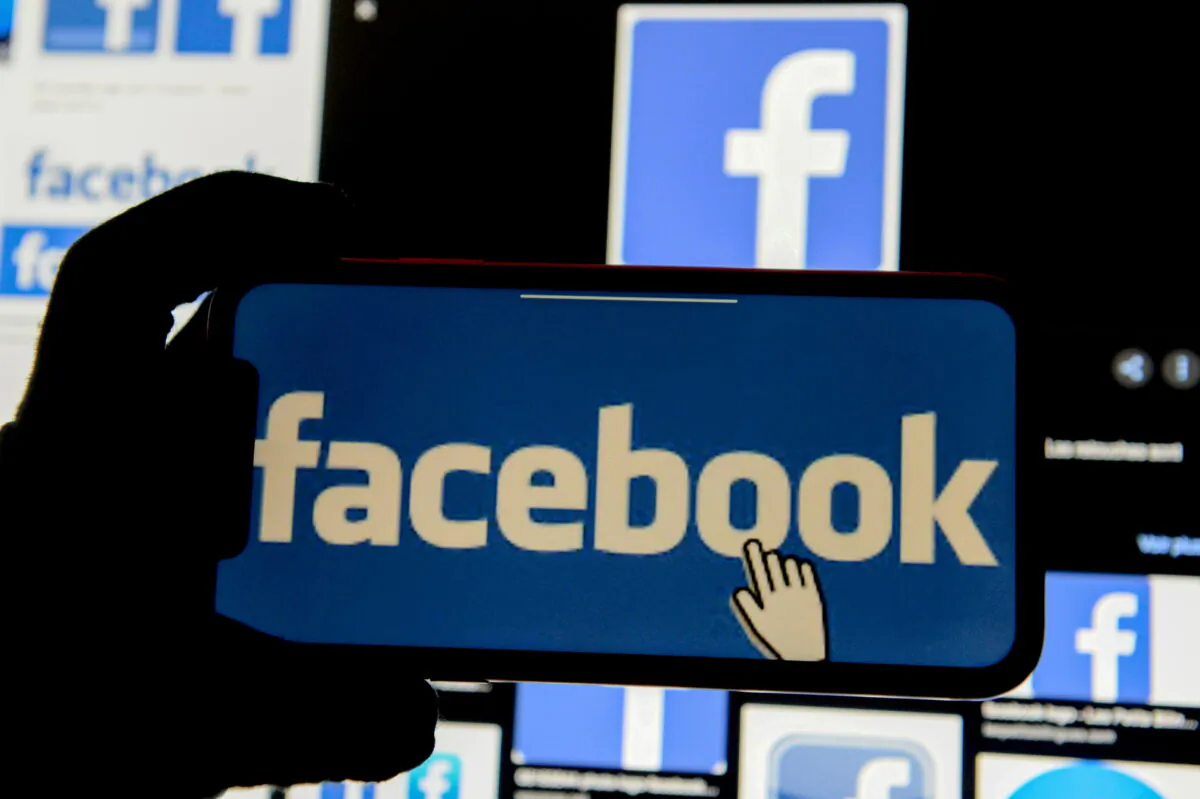 The Facebook logo is displayed on a mobile phone in this picture illustration taken on Dec. 2, 2019. (Johanna Geron/Illustration/Reuters)
