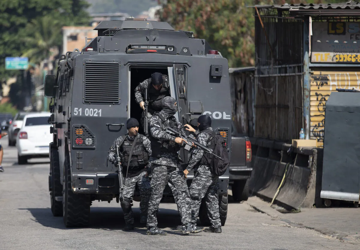 Police get out of an armored vehicle during an operation against alleged drug traffickers in the Jacarezinho favela of Rio de Janeiro, Brazil on May 6, 2021. (Silvia Izquierdo/AP Photo)