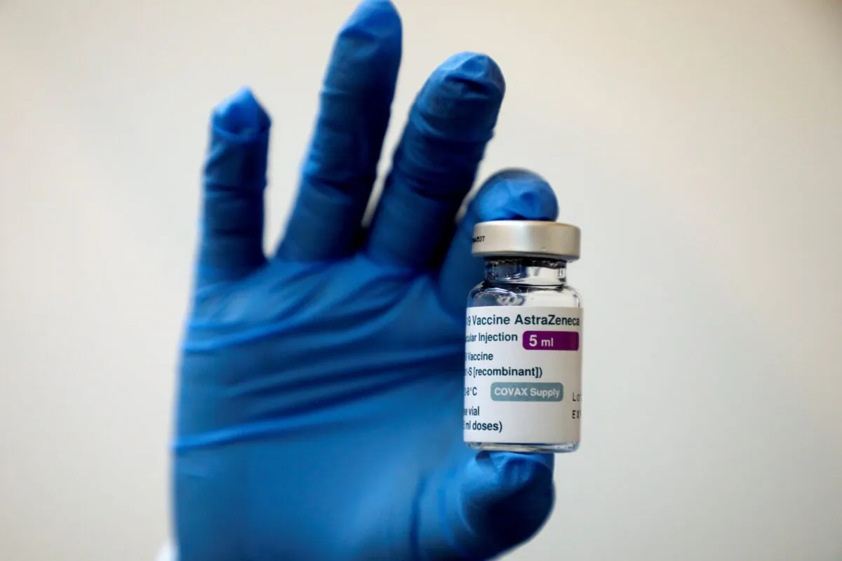 A medical worker holds a bottle of AstraZeneca's COVID-19 vaccine at a vaccination centre in Kuala Lumpur, Malaysia May 5, 2021 (Lim Huey Teng/Reuters)