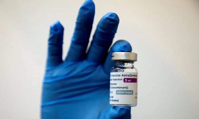 A medical worker holds a bottle of AstraZeneca's COVID-19 vaccine at a vaccination centre in Kuala Lumpur, Malaysia May 5, 2021 (Lim Huey Teng/Reuters)