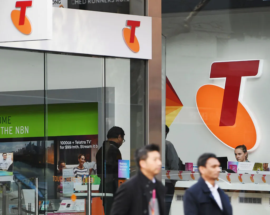 A Telstra logo is seen as pedestrian walk outside the Telstra Melbourne headquarters in Melbourne, Australia on June 14, 2017 (Michael Dodge/Getty Images)