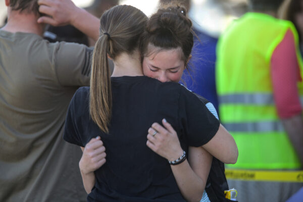 Students embrace after a school shooting