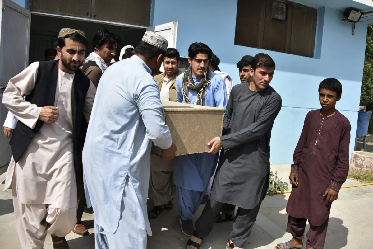 Relatives carry a coffin with the body of terlevion journalidst Nemat Rawan he was shot dead by gunmen, in Kandahar Province on May 6, 2021. (Javed Tanveer/AFP via Getty Images)